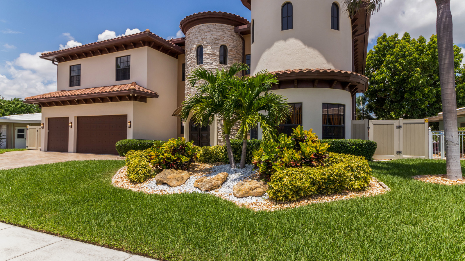 a concrete house with a beautiful landscaping in front