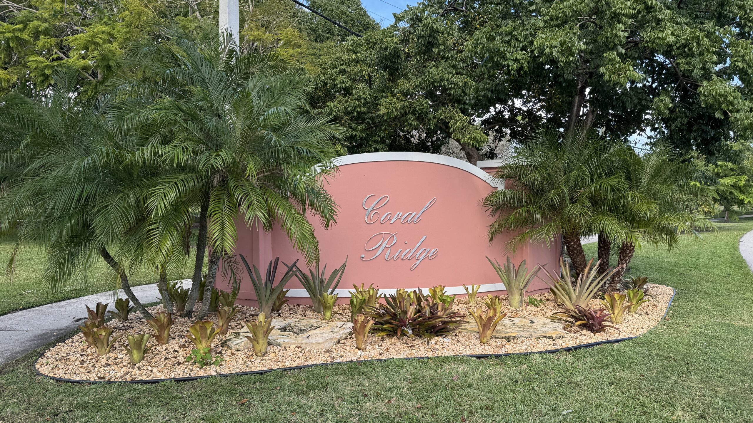 a peach colored signage of a neighborhood named Coral Ridge