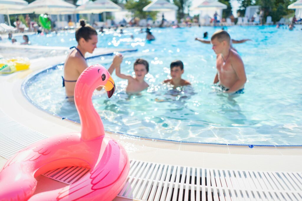 pink flamingo floater near a swiming pool and kids