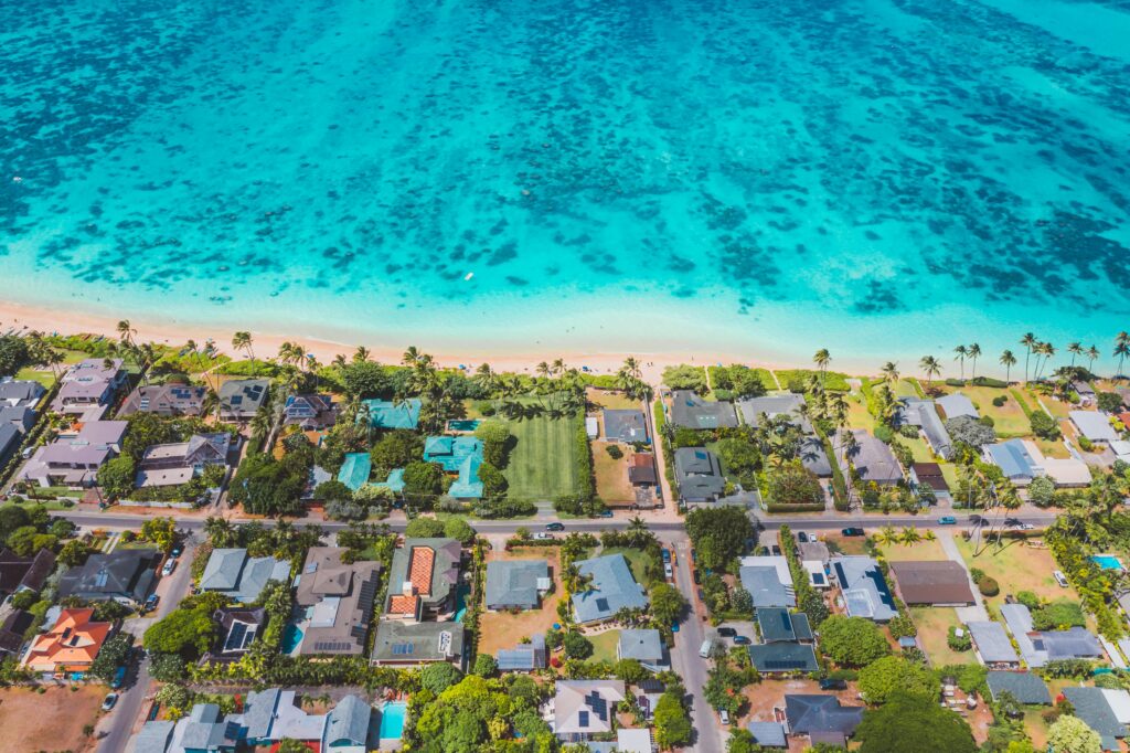 aerial view of houses and roads near body of water